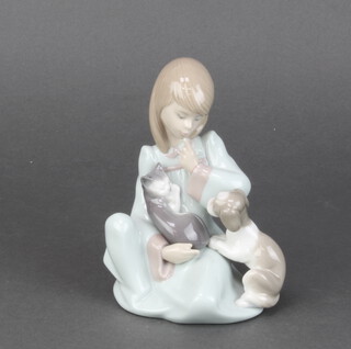 A Lladro figure of a seated girl with kitten and puppy 14cm, boxed