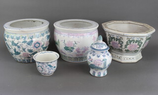 Three Chinese style blue and white pottery jardinieres, a chassepot and an urn and cover 