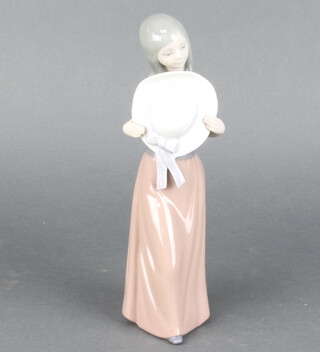 A Lladro figure of a young lady holding a straw hat 24cm 