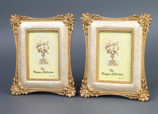 A pair of decorative gilt photograph frames 