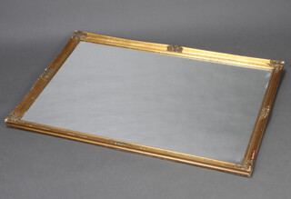 A rectangular plate wall mirror contained in a decorative gilt frame 99cm h x 67cm  w 