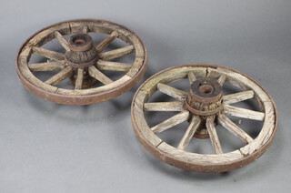 A pair of 19th Century 10 spoked iron shod cart wheels 69cm diam. 
