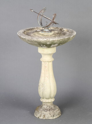 A metal armillary sphere raised on a reconstituted stone base (in 2 sections) 81cm h x 41cm diam. 