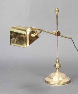 A gilt metal adjustable bank style desk lamp raised on a circular base 53cm h x 17cm 