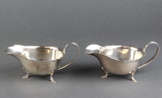 A pair of plated sauce boats