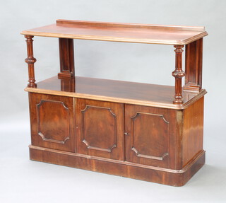A Victorian mahogany 2 tier buffet the base fitted a triple cupboard, raised on a platform base 109cm h x 135cm w x 52cm d 