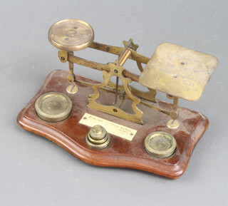 A set of mahogany and brass postage scales complete with weights