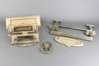 A brass letter box, 2 door handles and a door knocker 