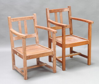 Castles, a near pair of slatted hardwood open arm chairs 