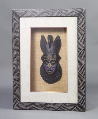 A Bakota mask contained in an ebonised frame 70cm x 52cm 
