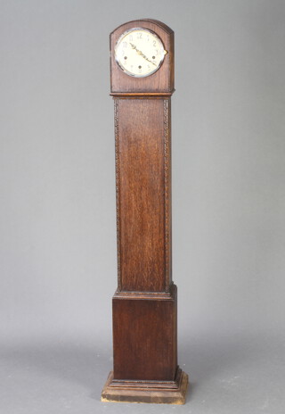 A 1930's chiming "granddaughter" clock with Arabic numerals, contained in an arched oak case 130cm h x 20cm w x 16cm d 