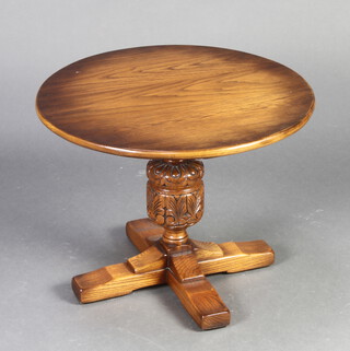 A circular oak pedestal table raised on cup and cover supports with cruciform base 66cm h x 61cm diam. 