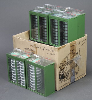 A collection of 12 Mitchell stacking drawers containing approx. 70 new spools of fishing line 
