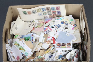 A quantity of world stamps, some on paper 