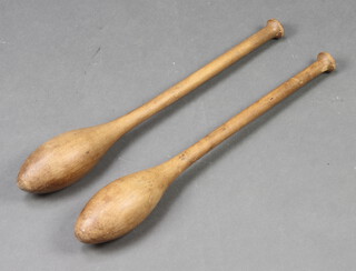 A pair of turned wooden Indian clubs 52cm 