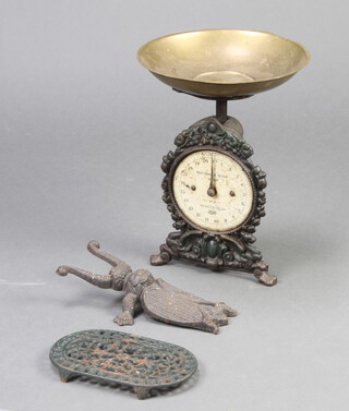 A Salters NO.49 household scales with brass pan, an iron boot jack in the form of a beetle and an oval green pierced metal teapot stand 