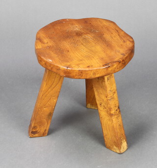 A circular elm stool raised on turned supports, base marked Wanderwood 31cm h x 31cm diam. 