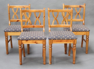 A set of 4 pine bar back dining chairs with upholstered drop in seats 