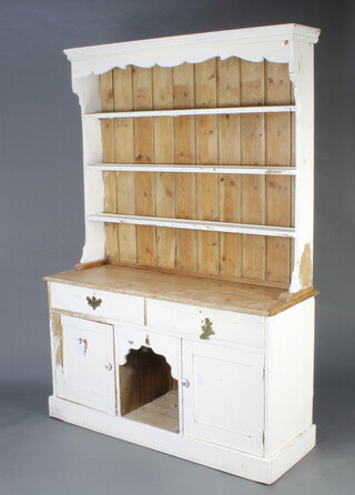 A 19th Century white painted pine dog kennel dresser, the raised back fitted 3 shelves, the base 2 drawers with recess flanked by a pair of cupboards 206cm h x 141cm w x 49cm d (the sides and front are partly stripped) 