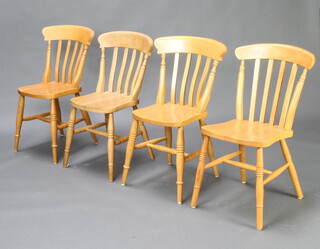 A harlequin set of 4 beech stick and rail back dining chairs raised on turned supports with H framed stretchers (3 and 1) 