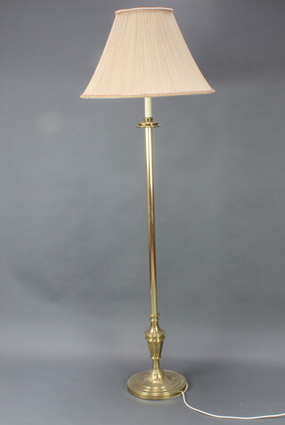 A gilt metal standard lamp raised on a circular base 132cm h x 27cm diam., some light corrosion to the base 