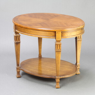 An American style oval crossbanded walnut 2 tier occasional table raised on square shaped supports 54cm x 68cm w x 55cm d 
