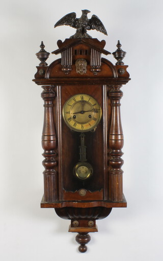 A striking Vienna style regulator with paper dial and Roman numerals, having a grid iron pendulum, contained in a walnut case (no key) 