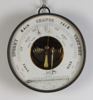 An aneroid barometer with enamelled dial contained in a circular metal case 20cm 