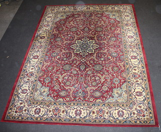 A red and white floral patterned machine made Persian style carpet with central medallion 347cm x 252cm 