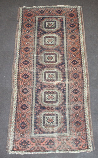 A red and blue ground Afghan rug with 6 octagons to the centre within multi row border 210cm x 94cm 