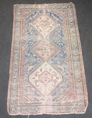 A pink and blue ground Persian rug with 3 stylised medallions to the centre within a multi row border 195cm x 105cm 