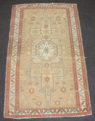 A Caucasian style rug with stylised medallion to the centre within a multi row border 218cm x 130cm 