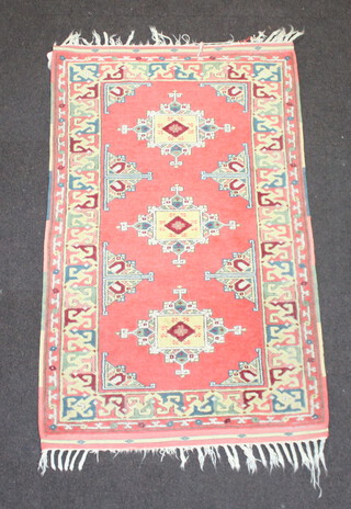 A Caucasian style rug with 3 stylised medallions to the centre 134cm x 81cm 