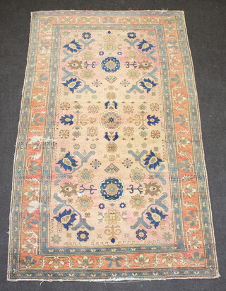 A pink, cream, green and floral patterned Caucasian style rug within a 3 row border 233cm x 140cm 