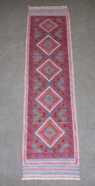 A red and blue ground Meshwani runner with 5 diamonds to the centre within a multi row border 255cm x 65cm 