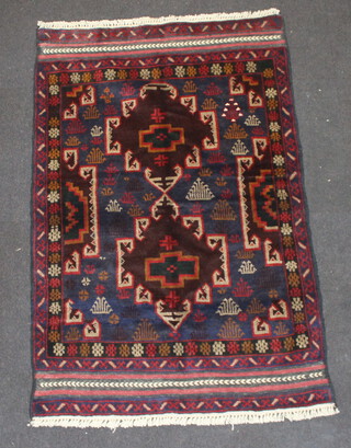 A brown, blue and red ground Belouche rug 139cm x 91cm  
