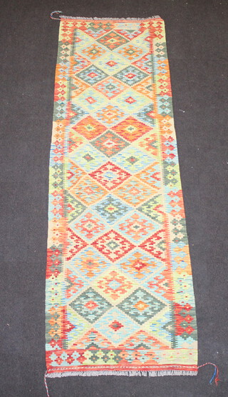 A tan, yellow and green ground Chobi Kilim runner with all over geometric design 248cm x 77cm 