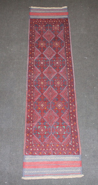 A red and blue ground Meshwani runner with 5 octagons to the centre within a multi row border 260cm x 63cm 