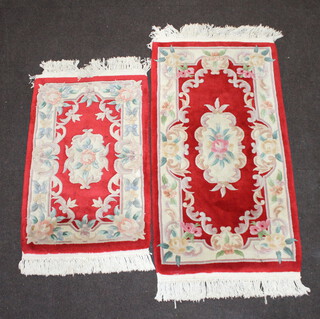 A white floral patterned Chinese rug 128cm x 70cm and 1 other 94cm x 96cm (both with some staining) 