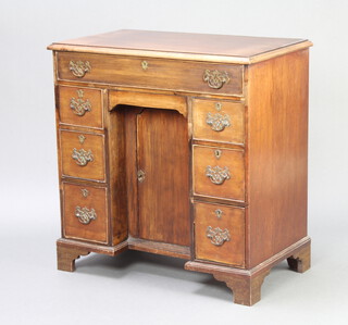 A Georgian bleached mahogany pedestal dressing/writing table fitted 1 long drawer, the kneehole fitted a cupboard enclosed by a panelled door, flanked by 3 drawers to each side, raised on bracket feet 81cm h x 79cm w x 44cm d  