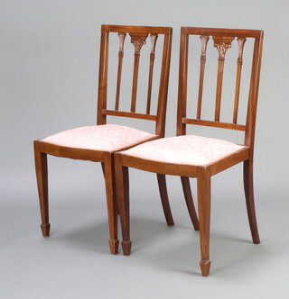 A pair of Edwardian Georgian style stick and rail back bedroom chairs with upholstered seats on square tapered supports, spade feet 
