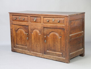 An 18th Century oak dresser base fitted 1 short and 2 long drawers above pair of arched panelled doors 81cm h x 146cm w x 55cm d 