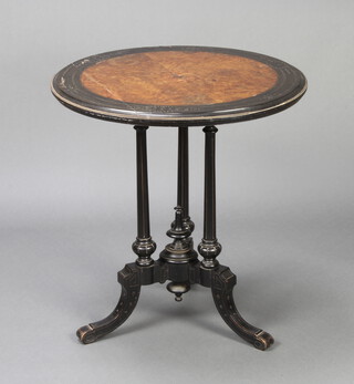 A Victorian aesthetic movement circular figured walnut, quarter veneered and ebonised occasional table with brass beading to the edge, raised on 3 turned columns 69cm h x 66cm diam.  