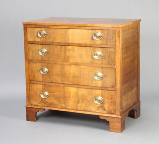 A Georgian style walnut chest of 4 long drawers with oval plate drop handles, raised on bracket feet 82cm h x 84cm w x 49cm d 