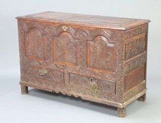 A 17th/18th Century heavily carved oak mule chest with hinged lid, original iron plate hinges and candle box (missing iron lock), the base fitted 2 drawers, raised on turned supports 86cm h x 129cm w x 54cm d 