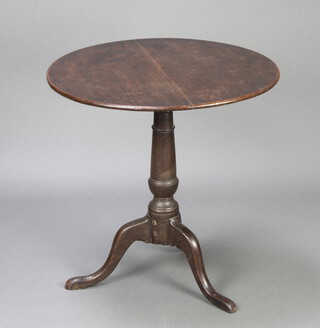 A Georgian circular oak snap top tea table raised on a turned column and tripod base 71cm h x 70cm diam. 