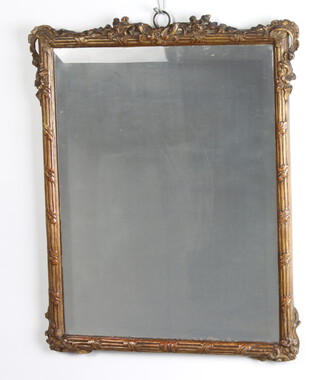 A rectangular bevelled plate mirror contained in a pierced gilt carved wood frame 44cm h x 37cm w 