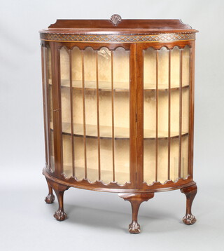 A 1930's Chippendale style mahogany bow front display cabinet with raised back, fitted shelves enclosed by astragal glazed panelled doors, raised on cabriole, ball and claw supports 129cm h x 107cm w x 41cm d 