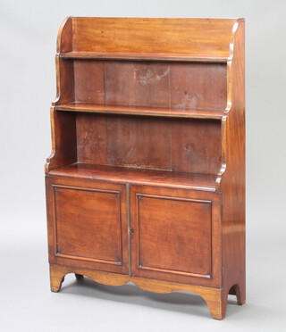 A 19th Century mahogany 3 tier waterfall bookcase, fitted a cupboard enclosed by a pair of panelled doors, raised on bracket feet 116cm h x 82cm w x 24cm w 