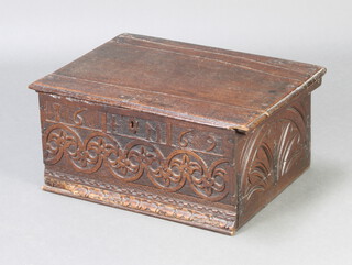An 18th/19th Century carved oak bible box with hinged lid and iron butterfly hinges, the apron carved 1696 IM, 23cm x 52cm x 37cm  